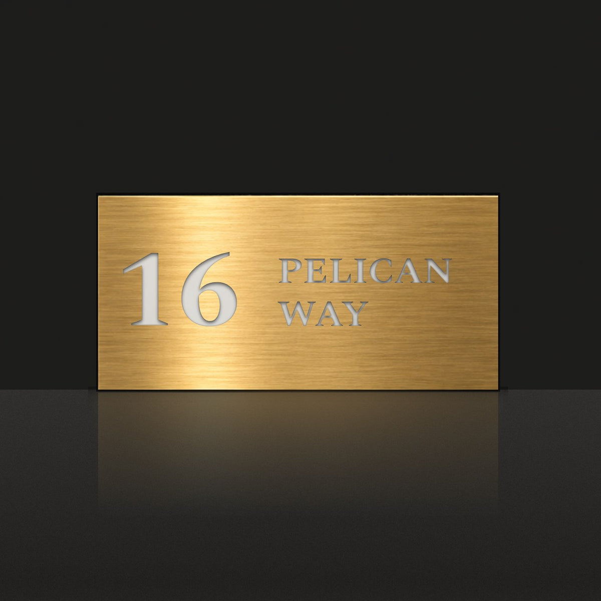 Brushed gold house number and street name sign with a brushed metal look, The Maleny, reading 16 Pelican Way in white lettering.
