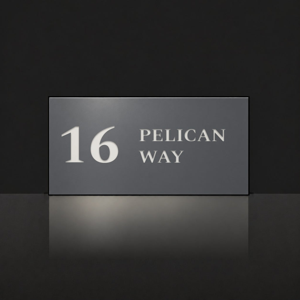 Matte charcoal house number and street name sign, The Maleny, reading 16 Pelican Way in white lettering.