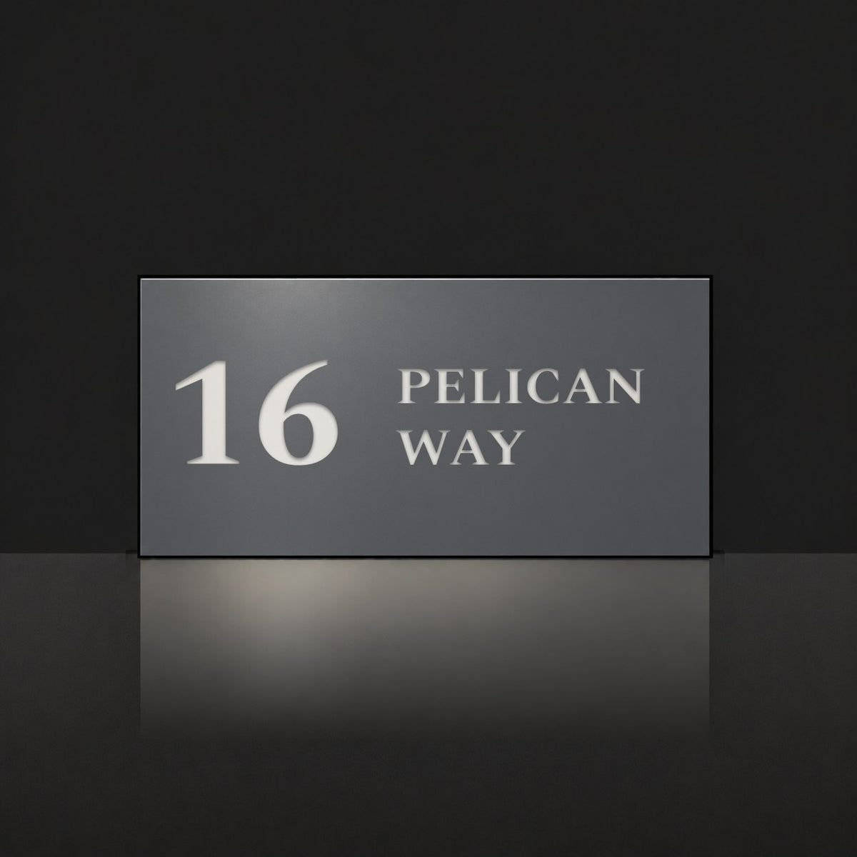 Matte charcoal house number and street name sign, The Maleny, reading 16 Pelican Way in white lettering.