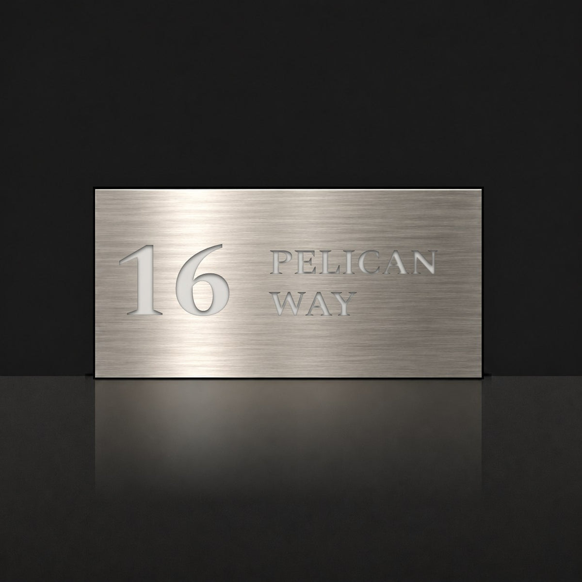 Brushed silver house number and street name sign with a brushed metal look, The Maleny, reading 16 Pelican Way in white lettering.
