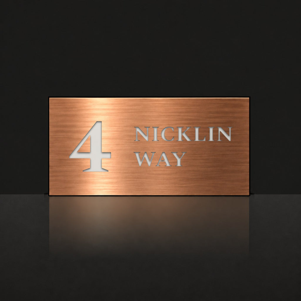Brushed copper house number and street name sign with a brushed metal look, The Marcoola, reading 4 Nicklin Way in white lettering.