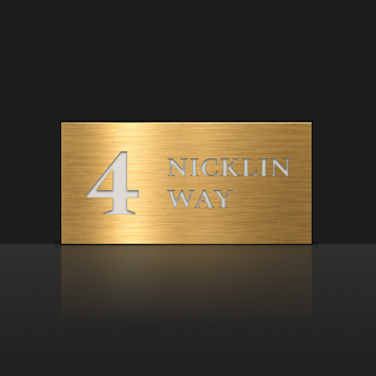 Brushed gold house number and street name sign with a brushed metal look, The Marcoola, reading 4 Nicklin Way in white lettering.