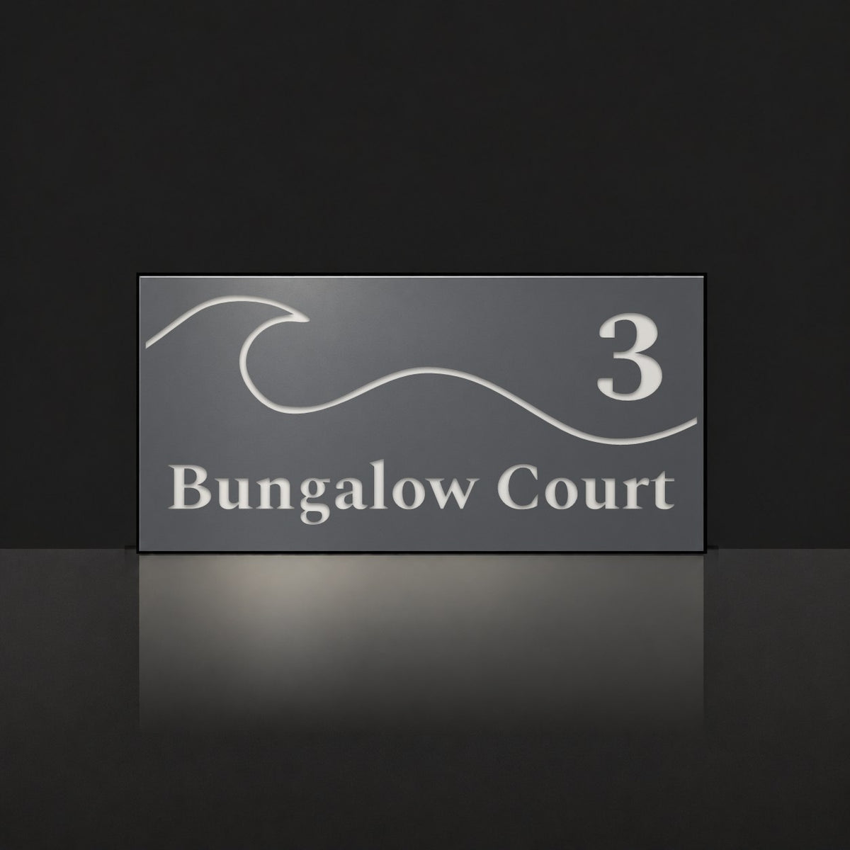 Matte charcoal house number and street name sign, The Moffat, reading 3 Bungalow Court in white lettering, with a wave.