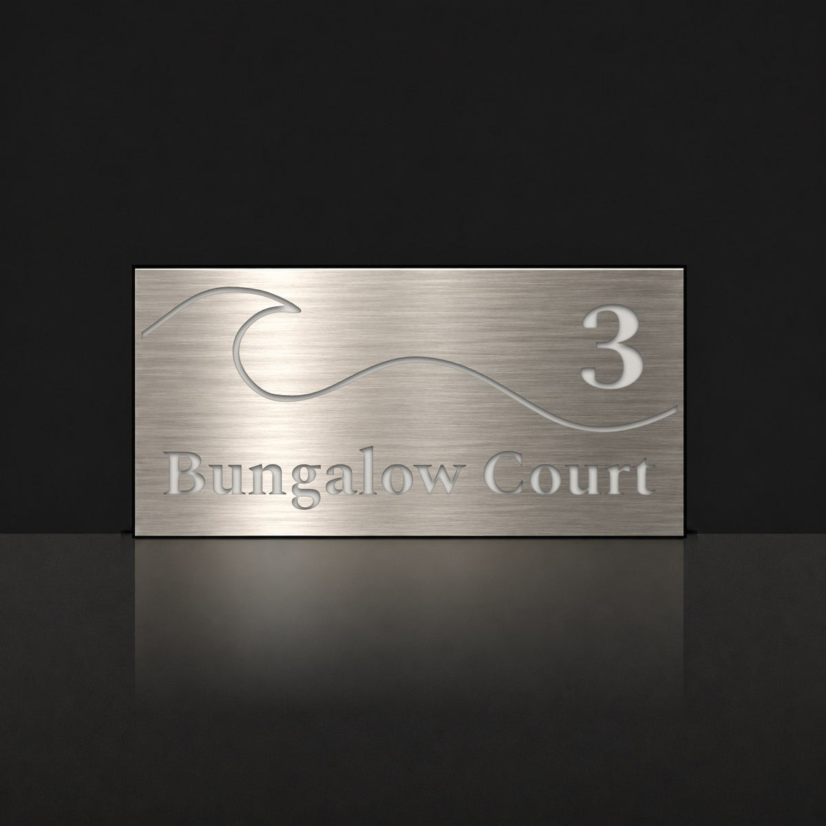Brushed silver house number and street name sign with a brushed metal look, The Moffat, reading 3 Bungalow Court in white lettering, with a wave.