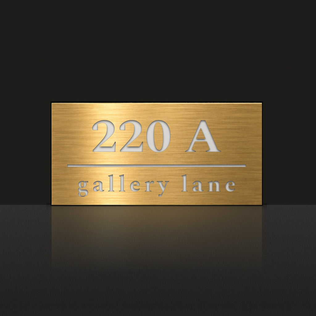 Brushed gold house number and street name sign with a brushed metal look, The Noosa, reading 220A Gallery Lane in white lettering.