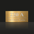 Brushed gold house number and street name sign with a brushed metal look, The Noosa, reading 220A Gallery Lane in white lettering.
