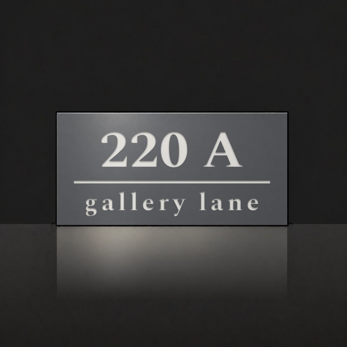 Matte charcoal house number and street name sign, The Noosa, reading 220A Gallery Lane in white lettering.