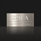 Brushed silver house number and street name sign with a brushed metal look, The Noosa, reading 220A Gallery Lane in white lettering.