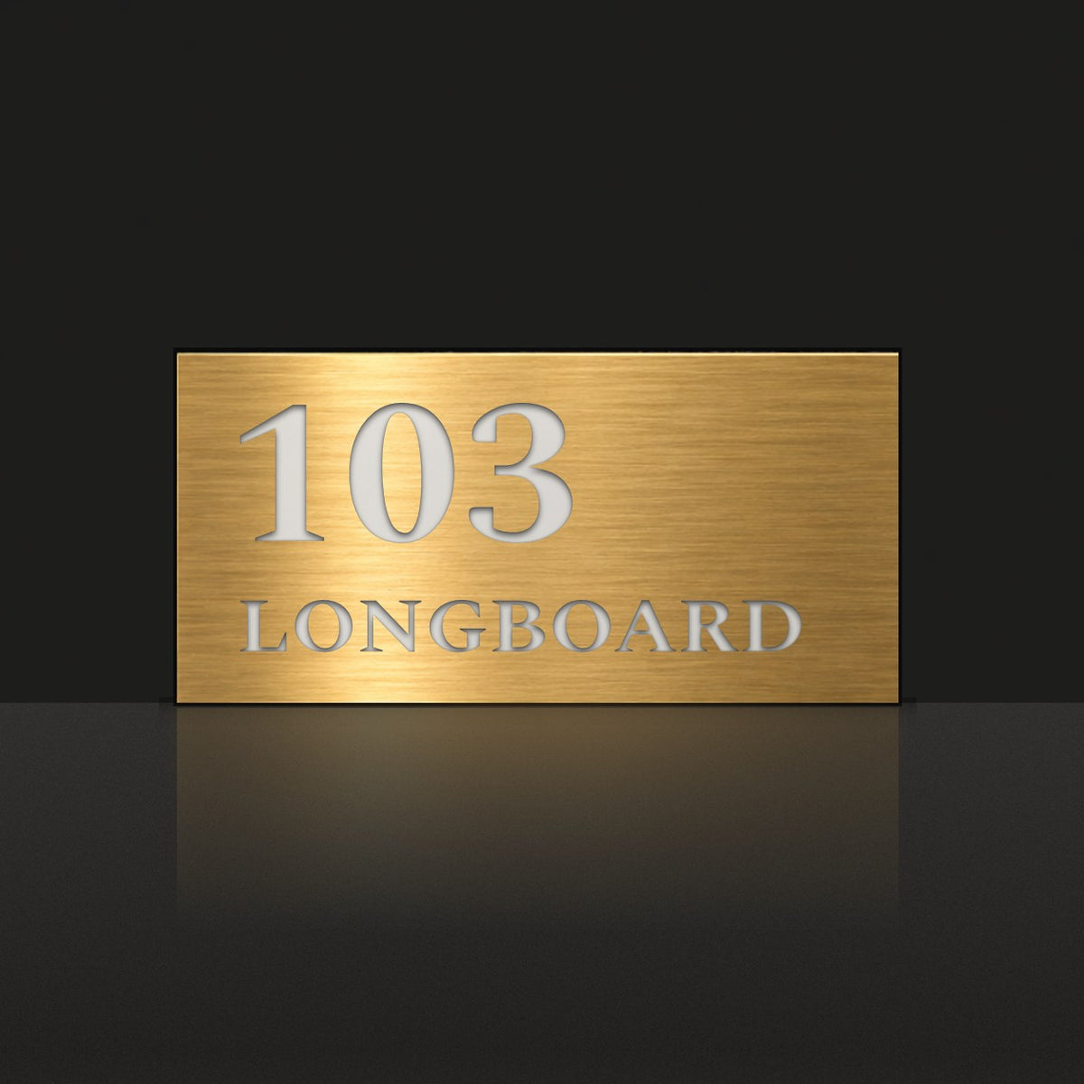 Brushed gold house number and street name sign with a brushed metal look, The Peregian, reading 103 Longboard in white lettering.