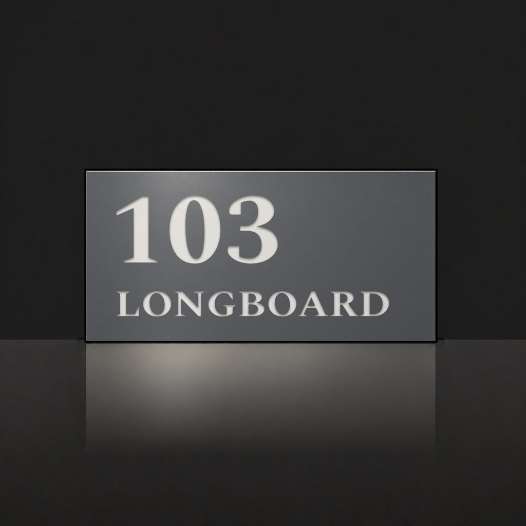 Matte charcoal house number and street name sign, The Peregian, reading 103 Longboard in white lettering.