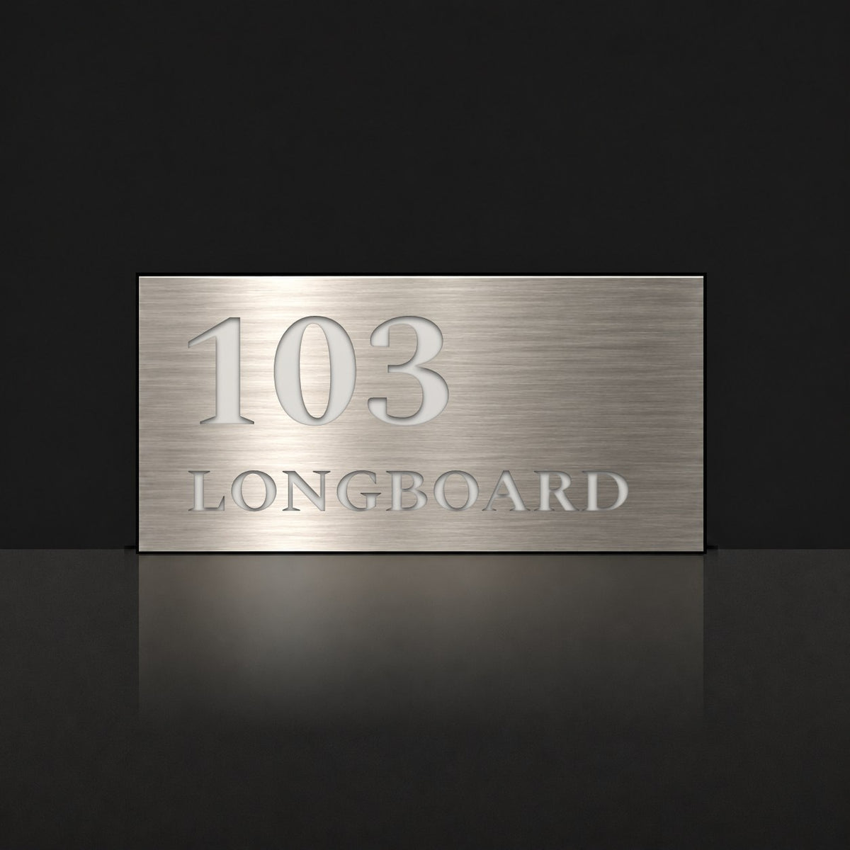 Brushed silver house number and street name sign with a brushed metal look, The Peregian, reading 103 Longboard in white lettering.