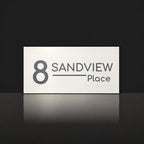 Matte white house number and street name sign, The Alexandra, reading 8 Sandview Place in charcoal lettering.