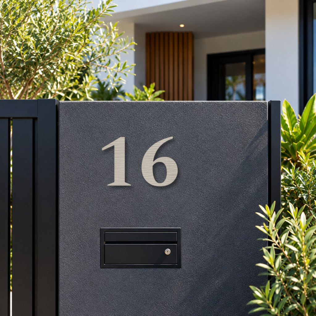 Brushed silver floating acrylic house number 16 in the heritage font on invisible standoffs, on a charcoal rendered pillar above a black letterbox.