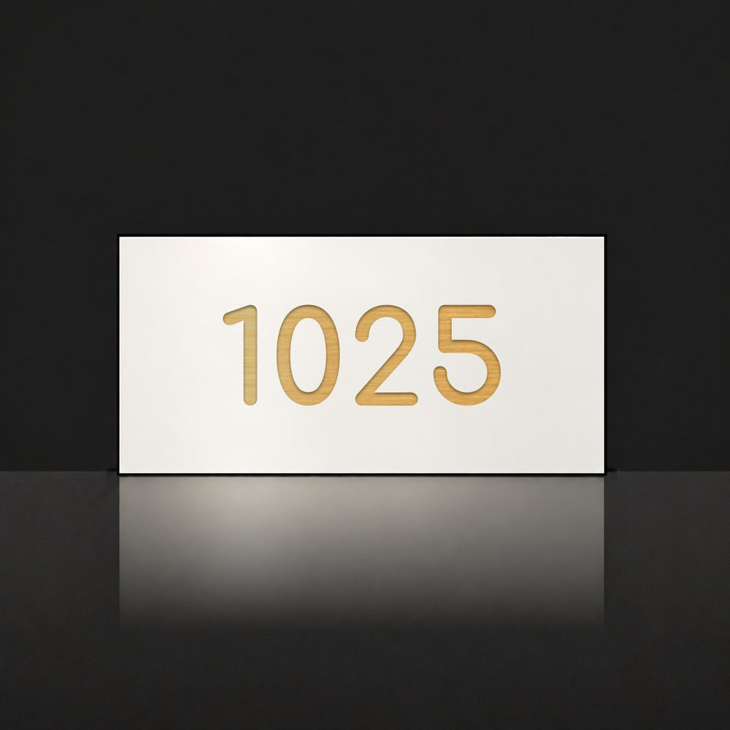 Brushed gold house number sign with a brushed metal look, The Kawana, white face with the number 1025 in gold lettering.