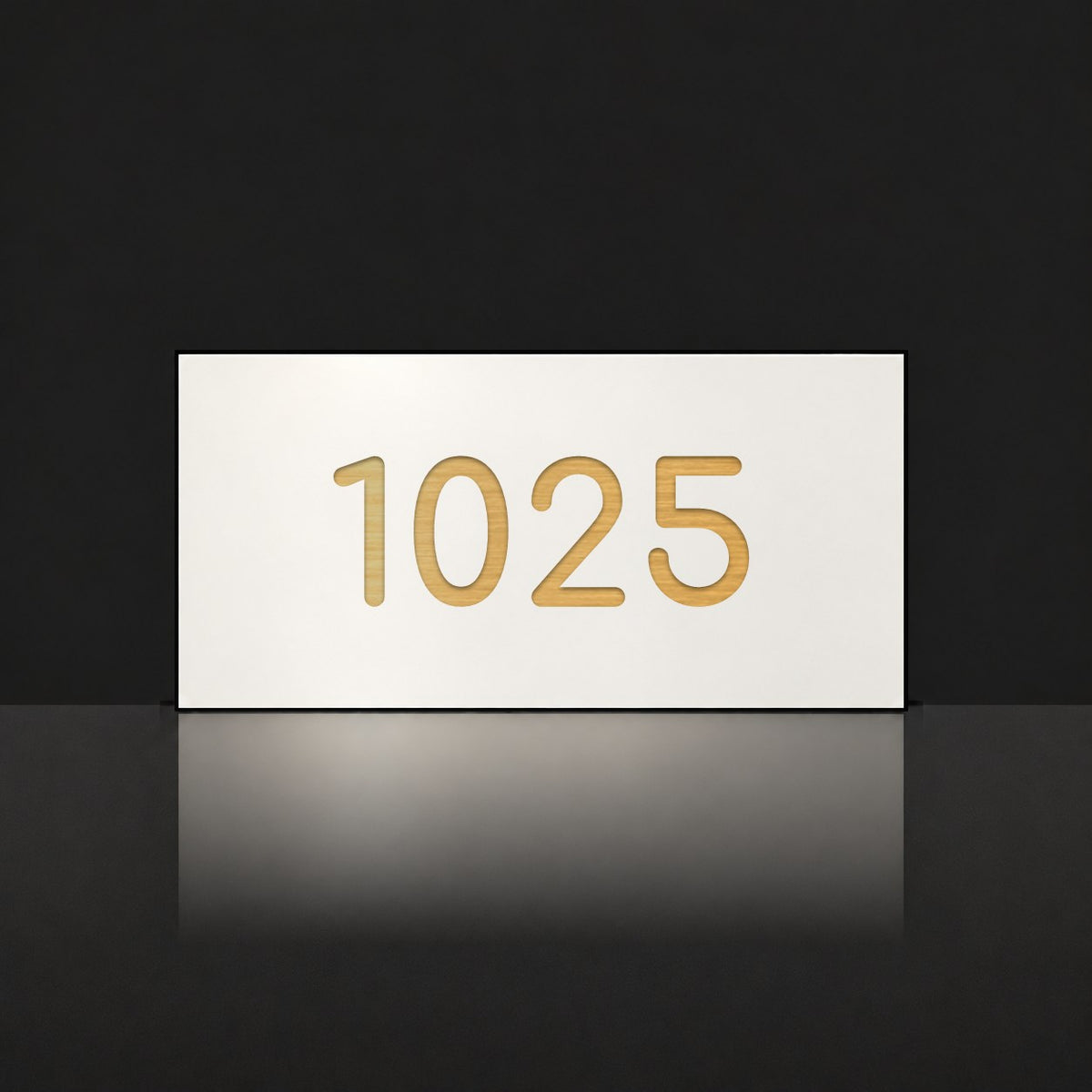 Brushed gold house number sign with a brushed metal look, The Kawana, white face with the number 1025 in gold lettering.
