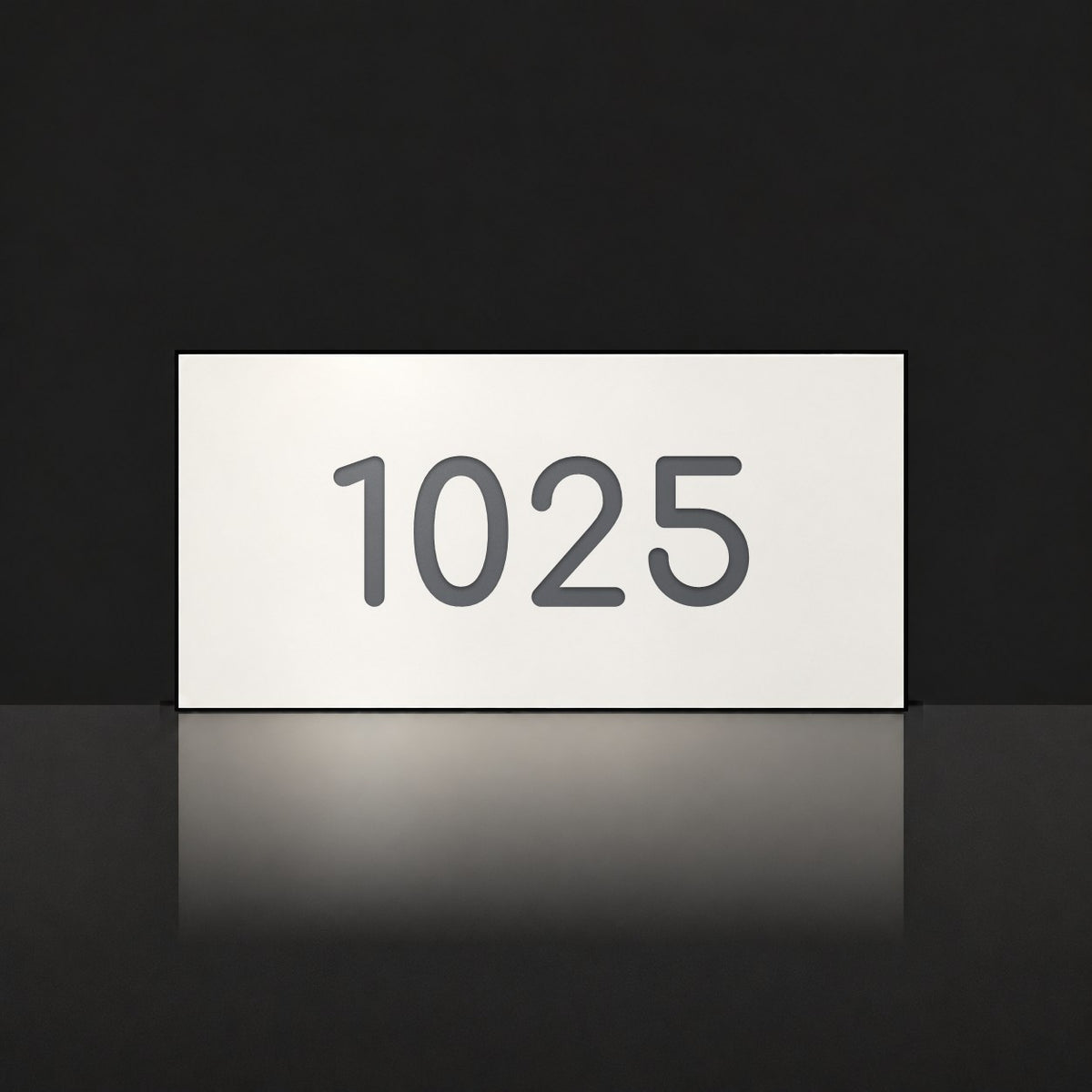 Matte white house number sign, The Kawana, with the number 1025 in charcoal lettering.