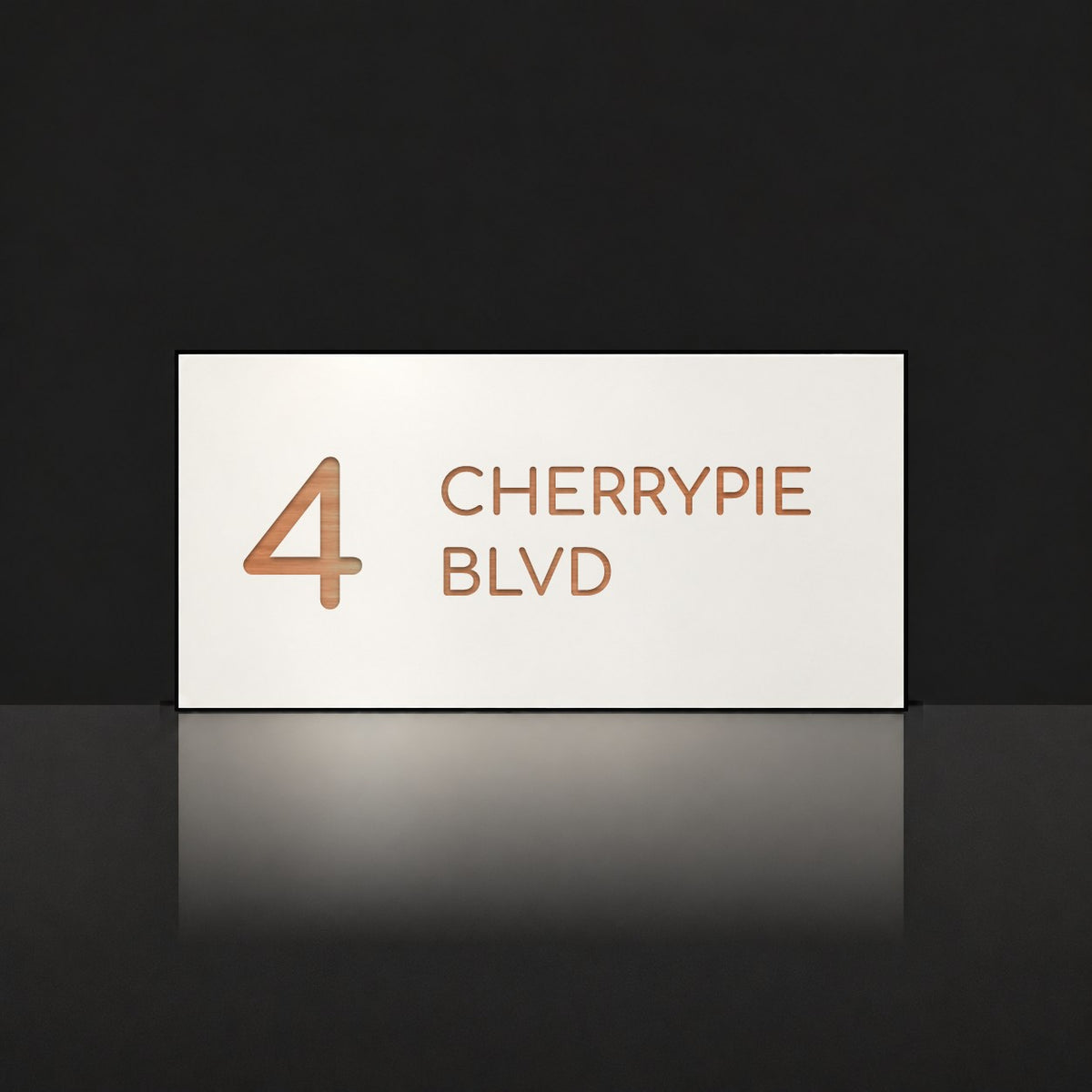 Brushed copper house number and street name sign with a brushed metal look, The Maleny, white face reading 4 Cherrypie Blvd in copper lettering.