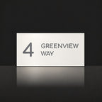 Matte white house number and street name sign, The Marcoola, reading 4 Greenview Way in charcoal lettering.