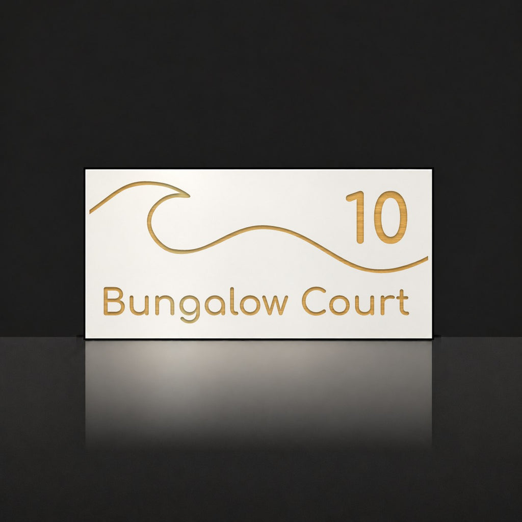 Brushed gold house number and street name sign with a brushed metal look, The Moffat, white face reading 10 Bungalow Court in gold lettering, with a wave.