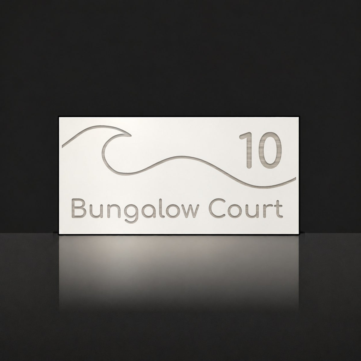 Brushed silver house number and street name sign with a brushed metal look, The Moffat, white face reading 10 Bungalow Court in silver lettering, with a wave.