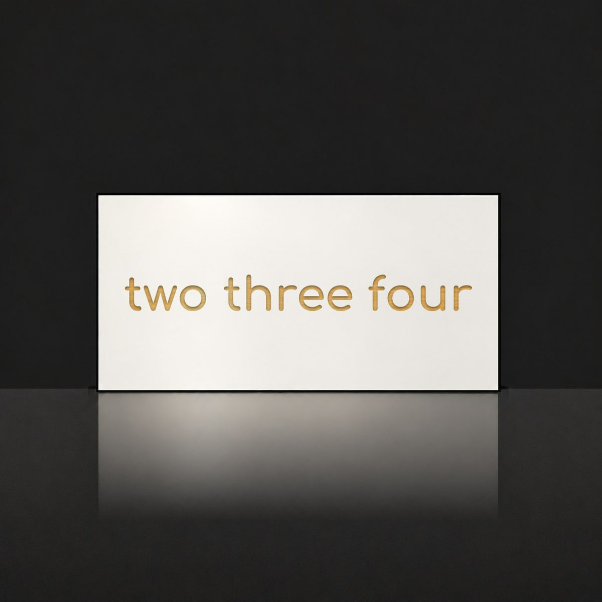 Brushed gold house number sign with a brushed metal look, The Montville, white face with the number spelled out as two three four in gold lettering.