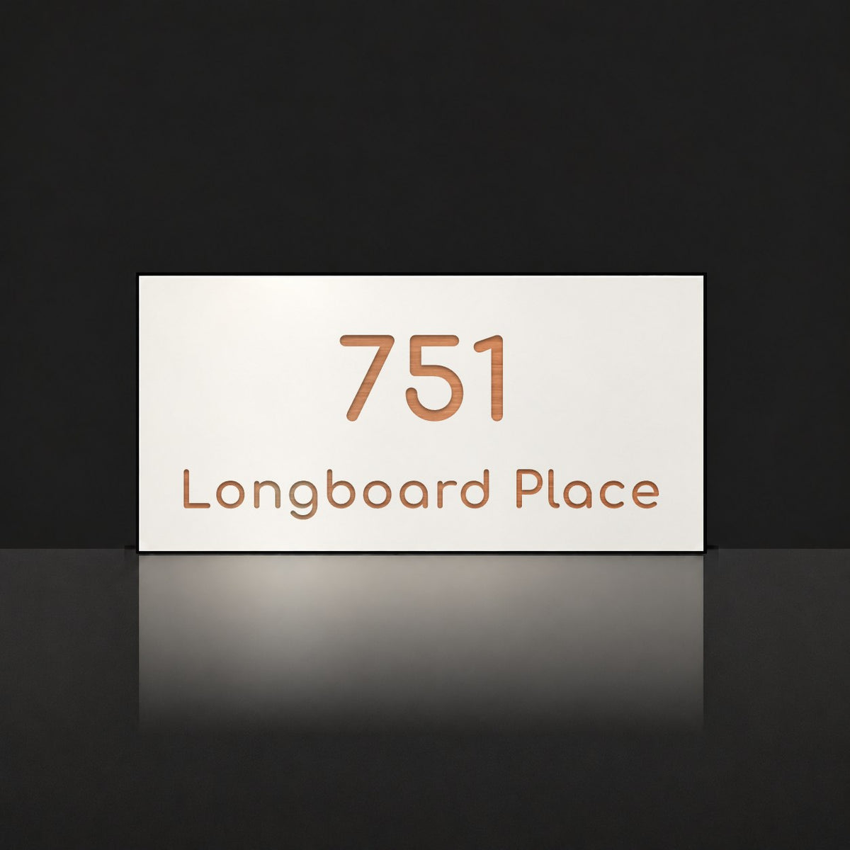 Brushed copper house number and street name sign with a brushed metal look, The Peregian, white face reading 751 Longboard Place in copper lettering.