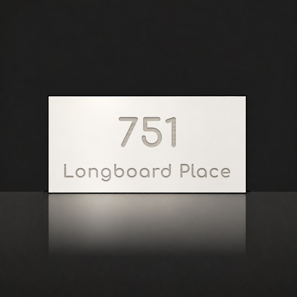 Brushed silver house number and street name sign with a brushed metal look, The Peregian, white face reading 751 Longboard Place in silver lettering.