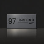 Matte charcoal house number and street name sign, The Alexandra, reading 97 Barefoot Way in black lettering.