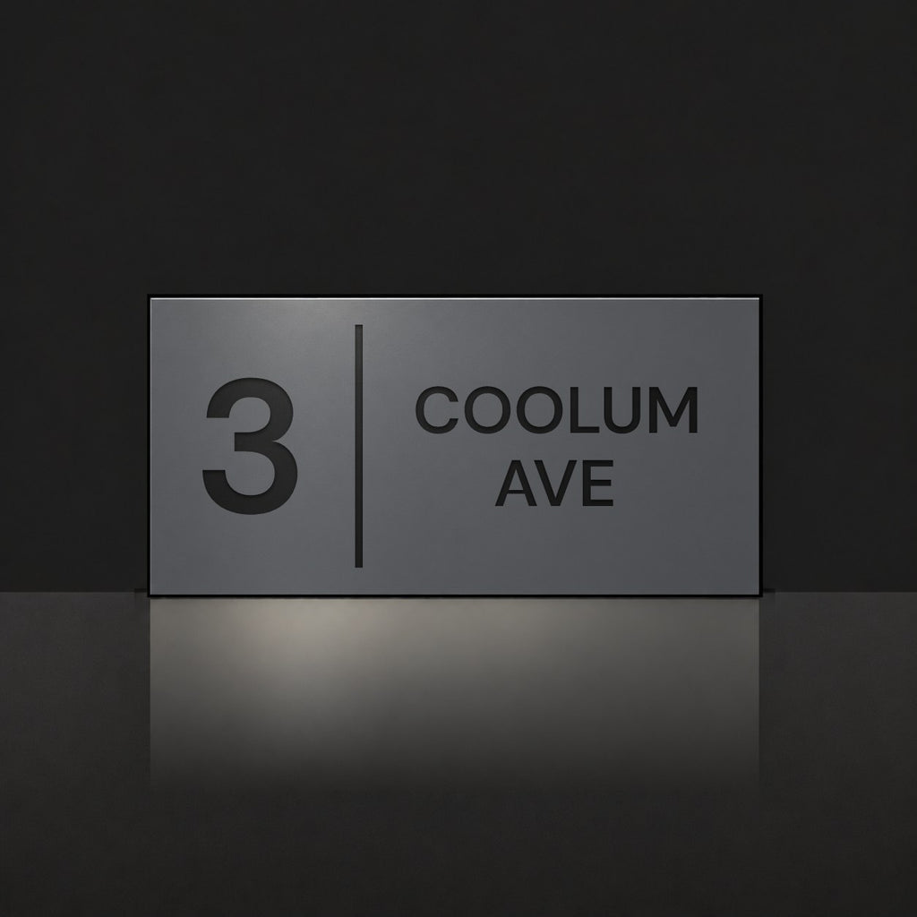 Matte charcoal house number and street name sign, The Coolum, reading 3 Coolum Ave in black lettering, with a dividing line.