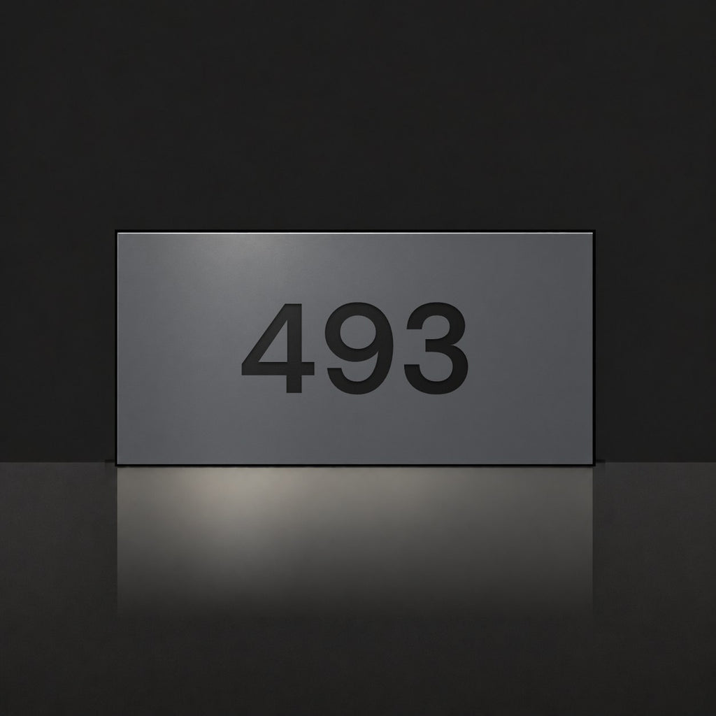 Matte charcoal house number sign, The Kawana, with the number 493 in black lettering.