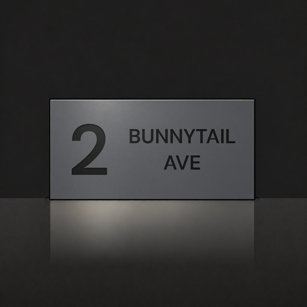 Matte charcoal house number and street name sign, The Maleny, reading 2 Bunnytail Ave in black lettering.