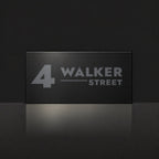 Matte black house number and street name sign, The Alexandra, reading 4 Walker Street in charcoal lettering.