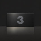 Matte black house number sign, The Kawana, with the number 3 in charcoal lettering.