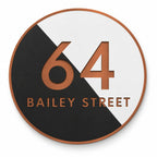 Copper round house number and street name sign reading 64 Bailey Street, split diagonally into black and white with brushed copper lettering and a copper rim, The Birtinya style.