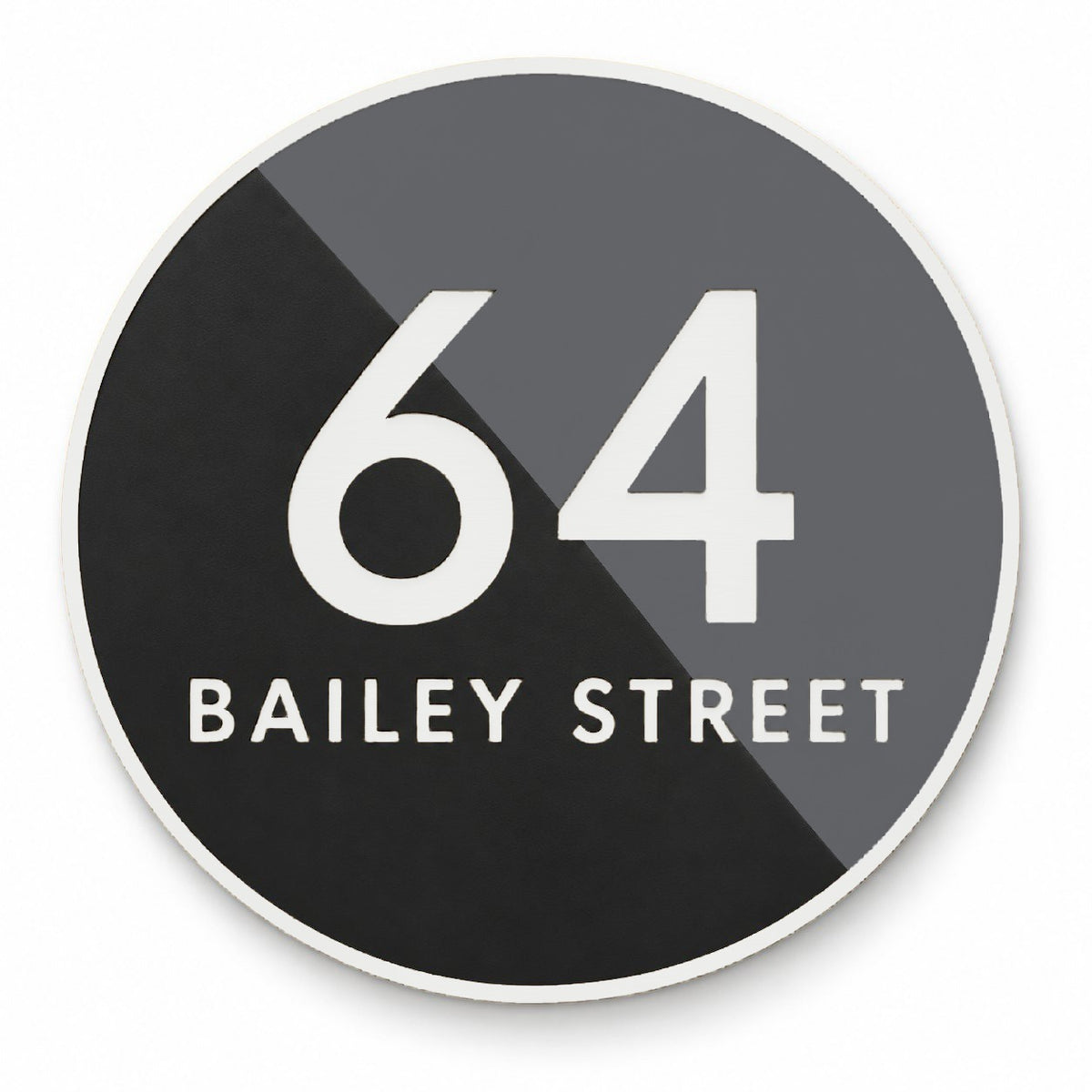 Matte round house number and street name sign reading 64 Bailey Street, split diagonally into black and charcoal with white lettering and a white rim, The Birtinya style.