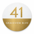 Gold round house number and street name sign reading 41 Graceview Blvd, white top half with a brushed gold number over a brushed gold bottom half with a white street name, The Buddina style.
