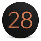 Black round house number sign with the number 28 in brushed copper, The Caloundra style, on a plain white background.