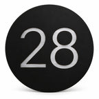 Black round house number sign with the number 28 in brushed silver, The Caloundra style, on a plain white background.