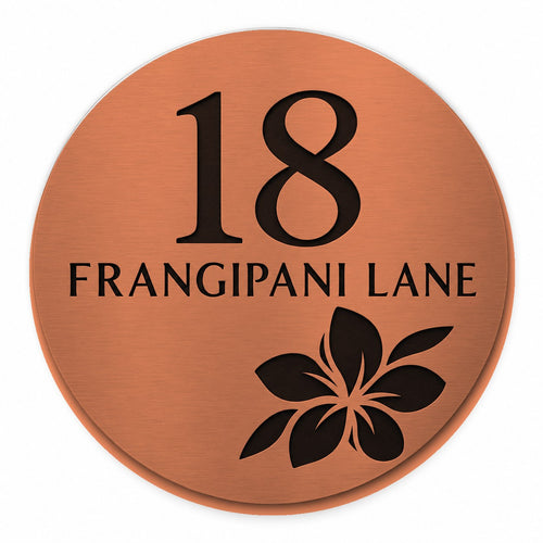 Brushed copper round house number and street name sign reading 18 Frangipani Lane with a frangipani flower cut through to black, The Currimundi style, on a plain white background.