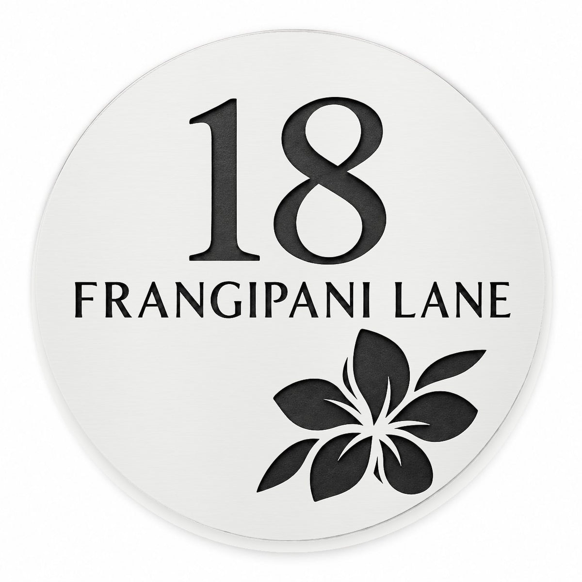 Matte white round house number and street name sign reading 18 Frangipani Lane with a frangipani flower cut through to black, The Currimundi style, on a plain white background.